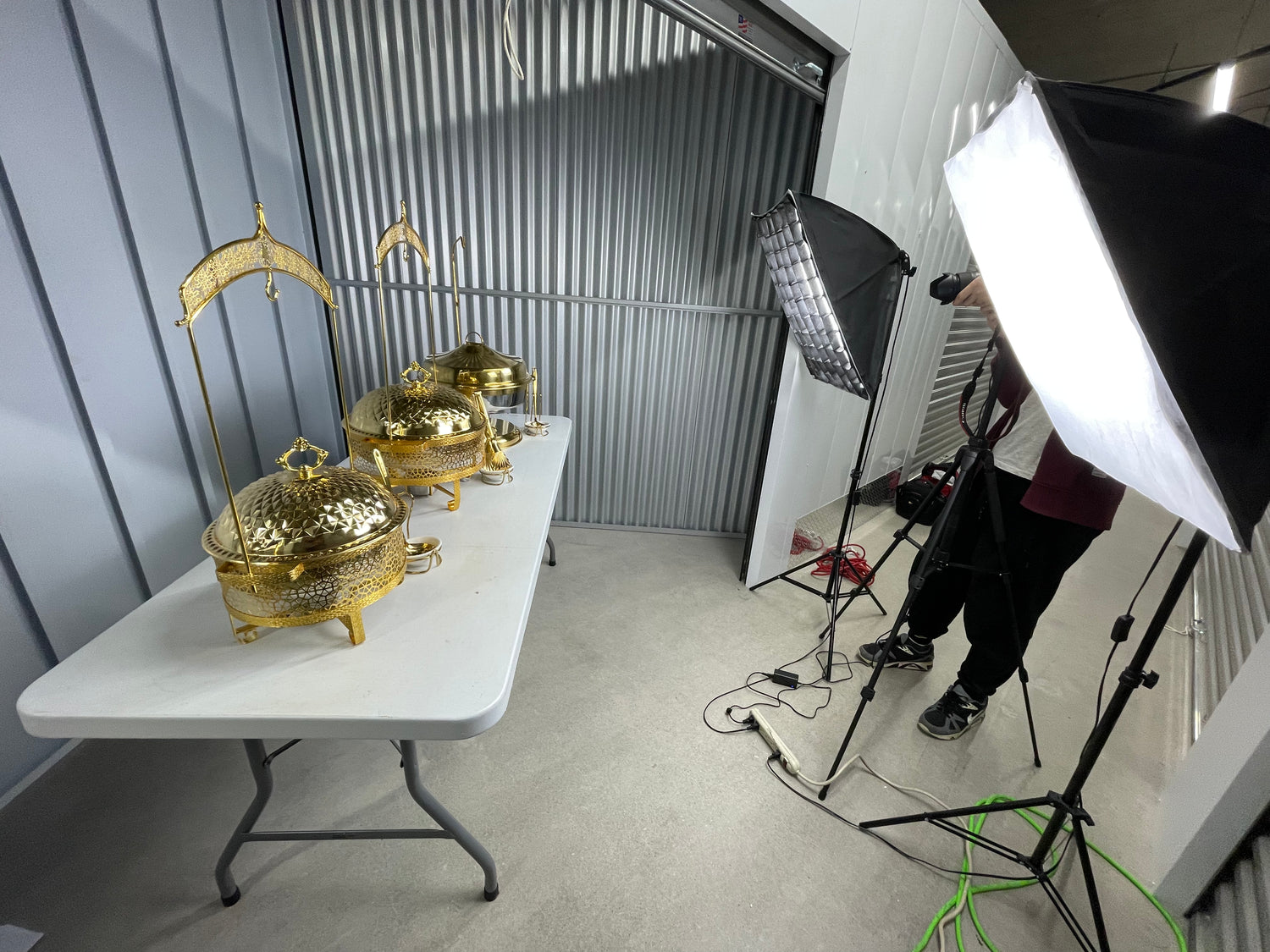 Gold decorative items on a table with photography equipment in a studio setting.