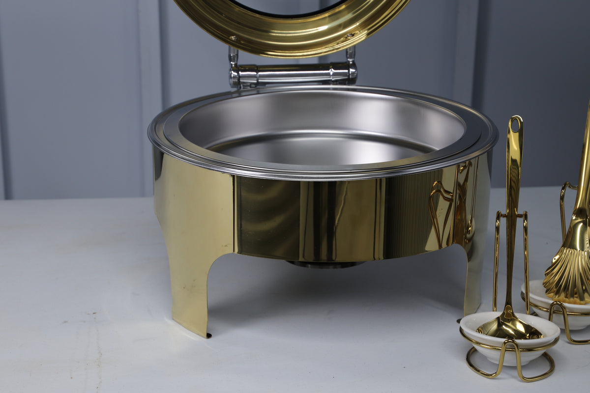 Close-up of the open gold Crystal Crown round chafing dish and its stainless food pan
