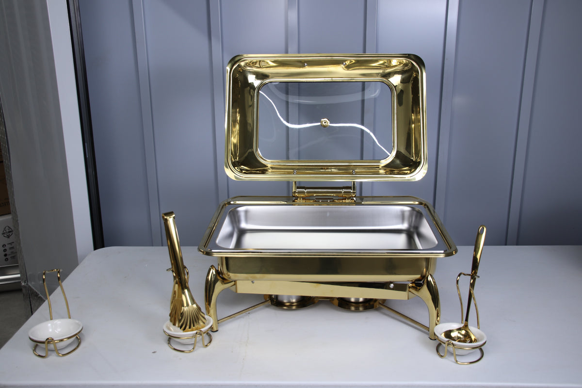 Gold Luxury Dining rectangle chafing dish open, with gold serving spoons and tongs in holders