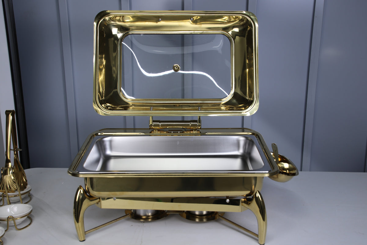 Gold Luxury Dining rectangle chafing dish with the lid raised on a table