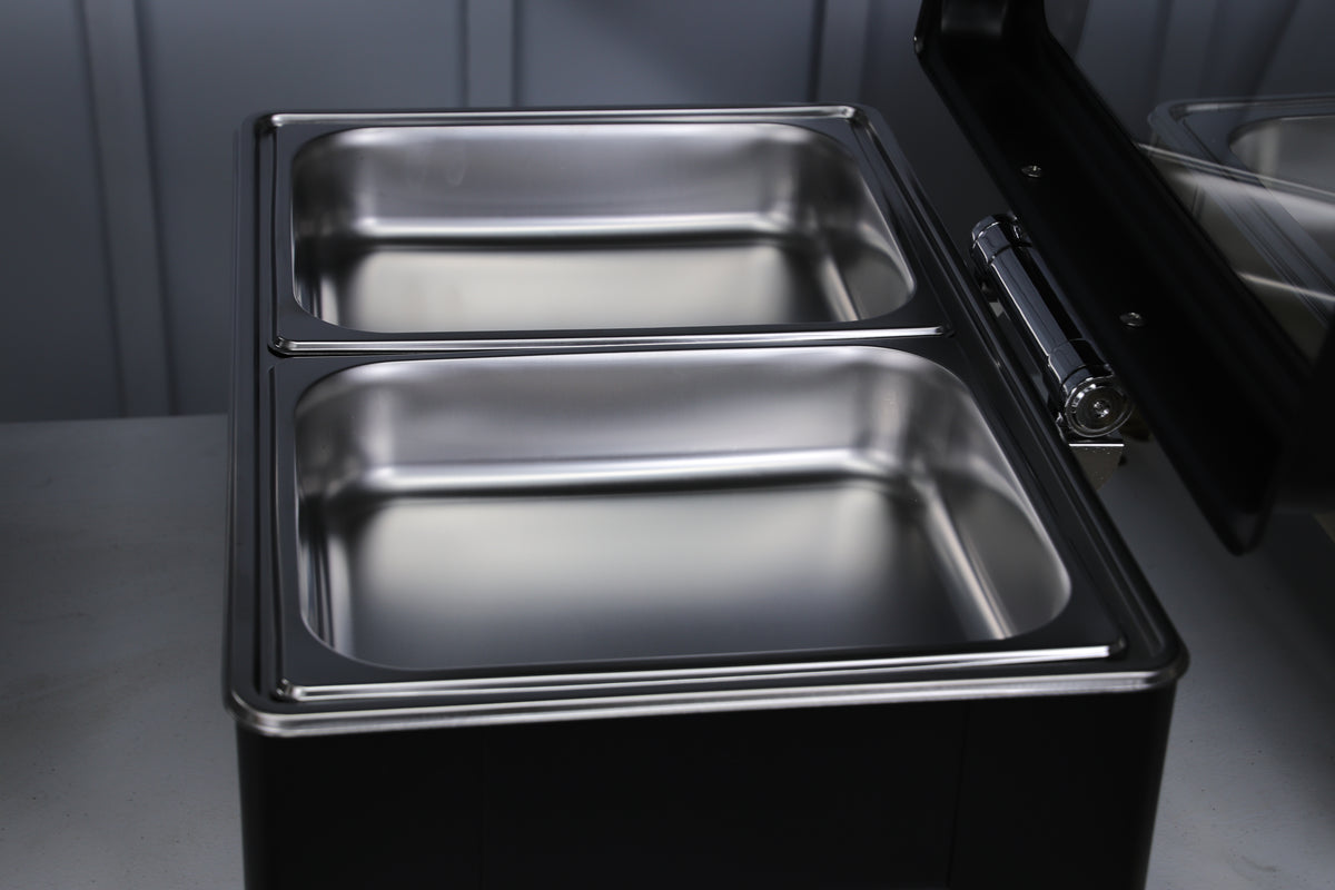 Jet black Crystal Crown chafing dish with the lid open and two stainless food pans inside