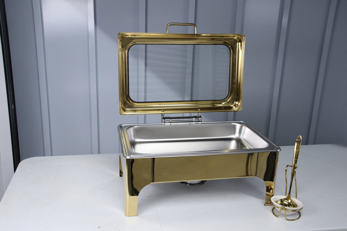 Gold Crystal Crown rectangle chafing dish with the lid open beside a serving spoon in its holder