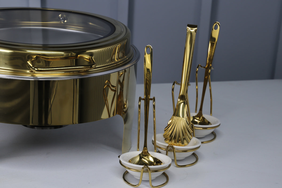 Gold Crystal Crown round chafing dish with a gold serving spoon and tongs in holders