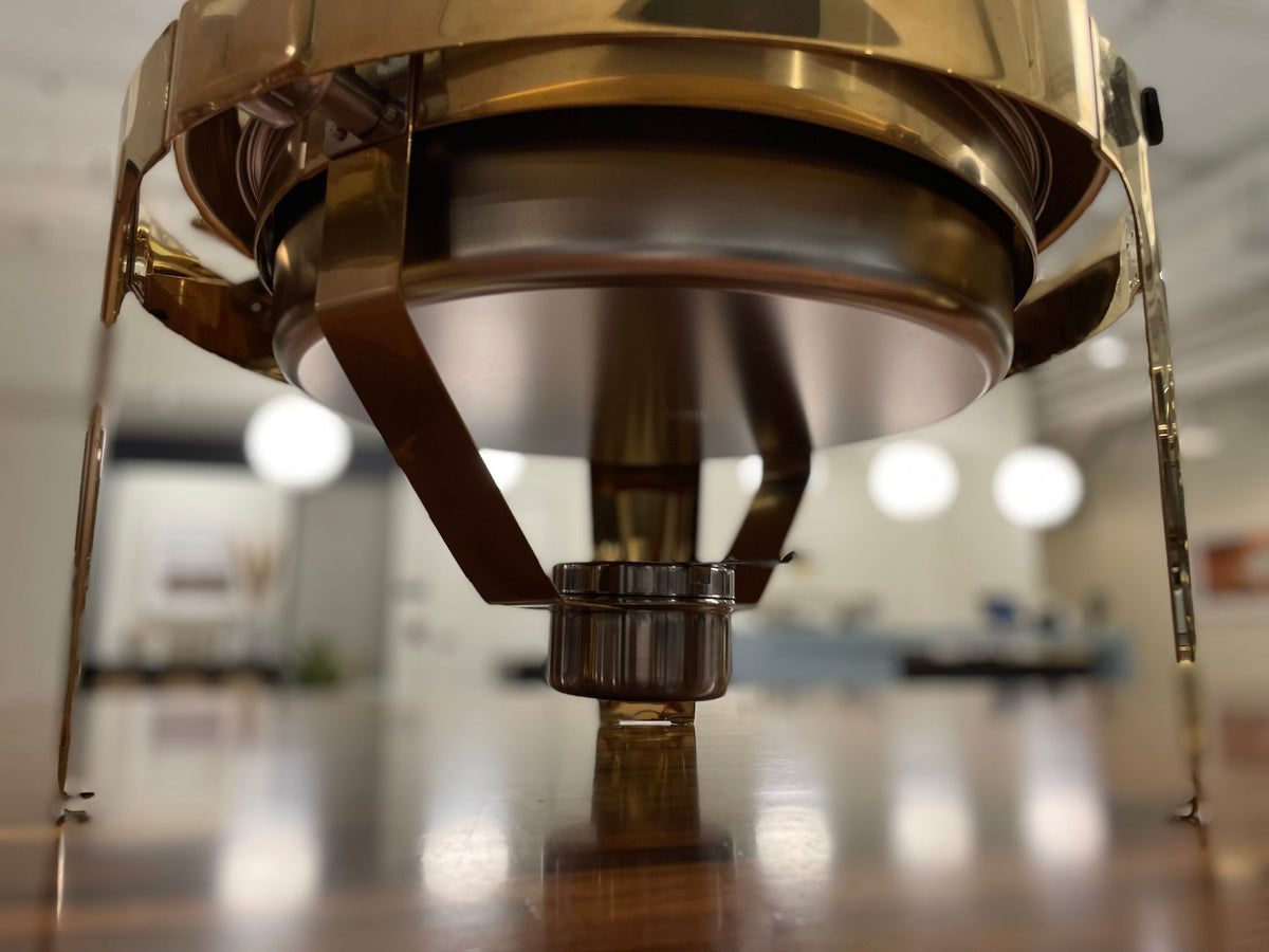 Underside of the gold Rolling Top chafing dish showing the fuel holder