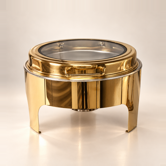Gold Crystal Crown round chafing dish, 6 litre, with a glass lid, on a warm off-white studio background