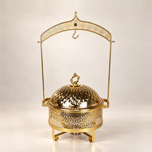 Gold Luxury Dining hanging chafing dish, 8 litre, with a patterned dome lid on an ornate hanging frame, on a warm off-white studio background