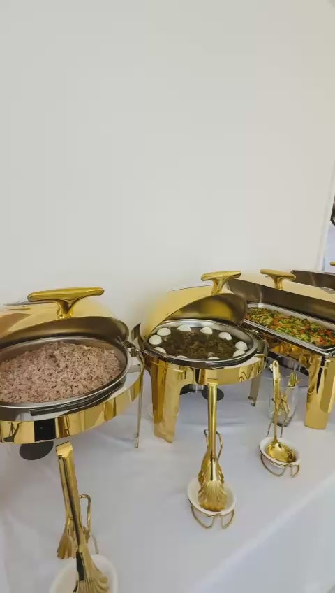 Customer video: gold chafing dishes on a buffet table, panning across the event room to a dessert table