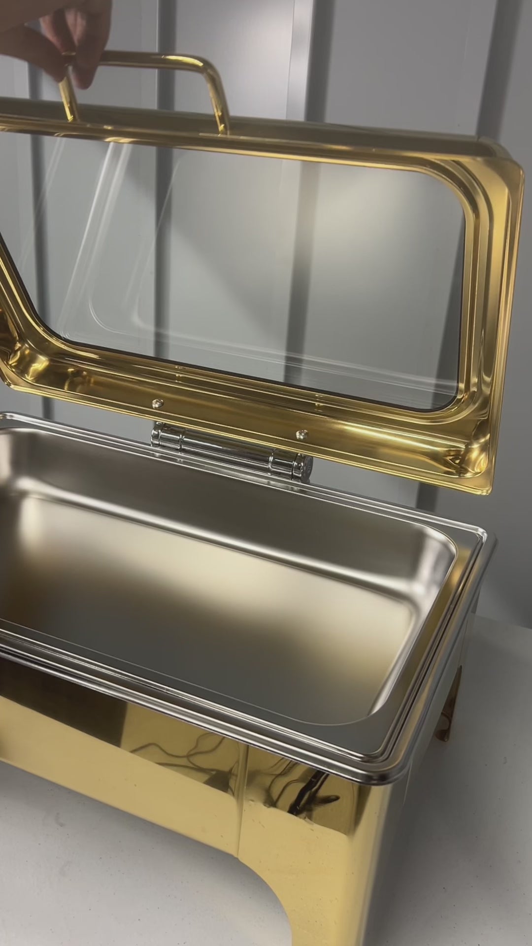 Video: lifting the glass lid on a gold Crystal Crown rectangle chafing dish