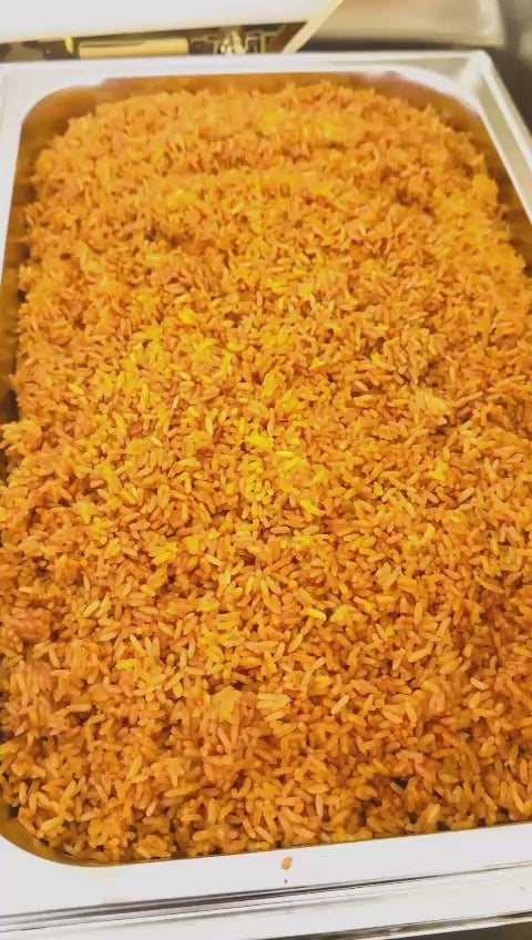 Customer video: close-ups of jollof rice, fried rice, and stew with boiled eggs in gold chafing dishes