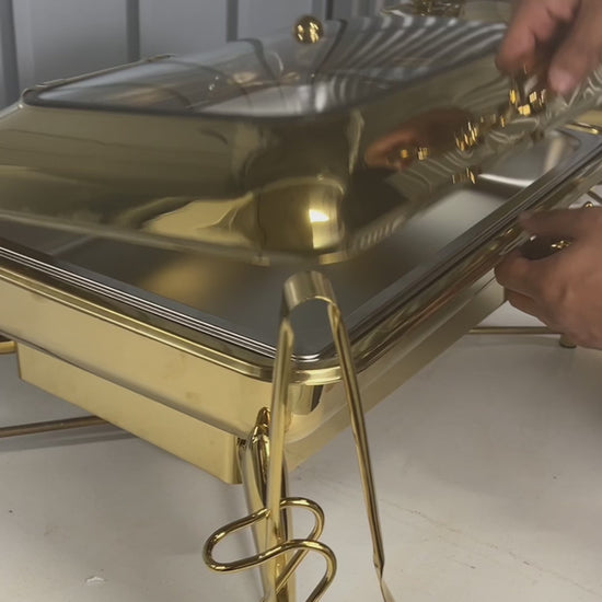 Video: lifting the glass lid on a gold rectangle chafing dish